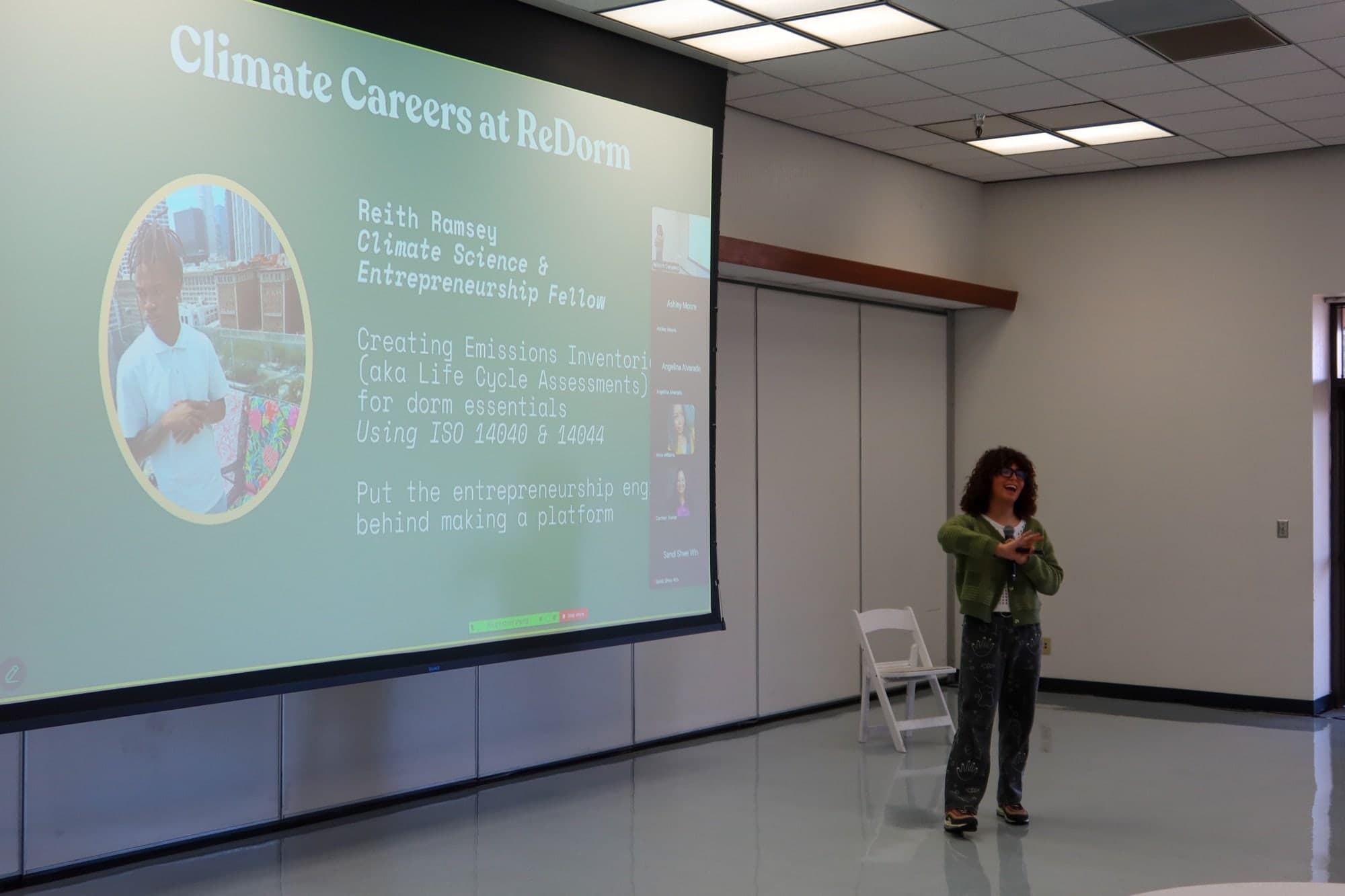 JJ Flores speaks into a microphone beside a projected slide titled Climate Careers at ReDorm