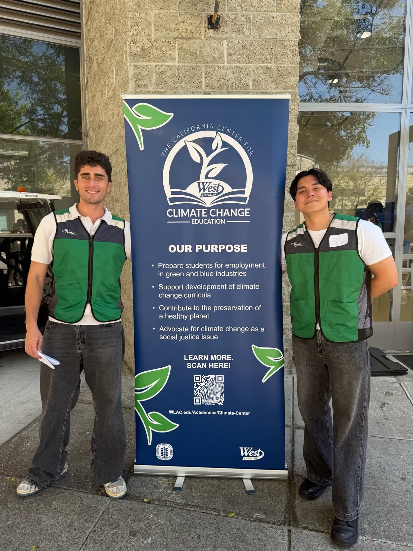 Ali Zarenezhad and Jose Guzman-Wug in ReDorm vests beside a California Center for Climate Change Education banner at West Los Angeles College